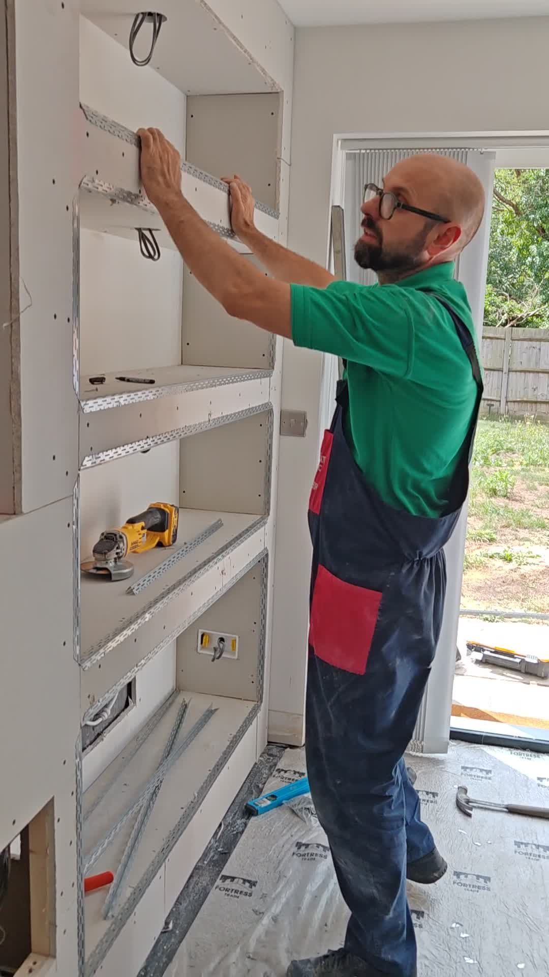 Built.Calm fitting metal stud framing into a media wall recess