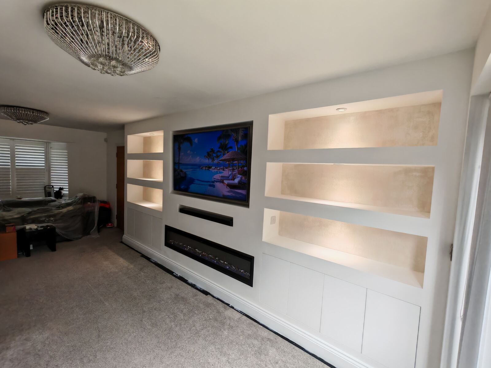 Media wall shelving recess with warm lighting