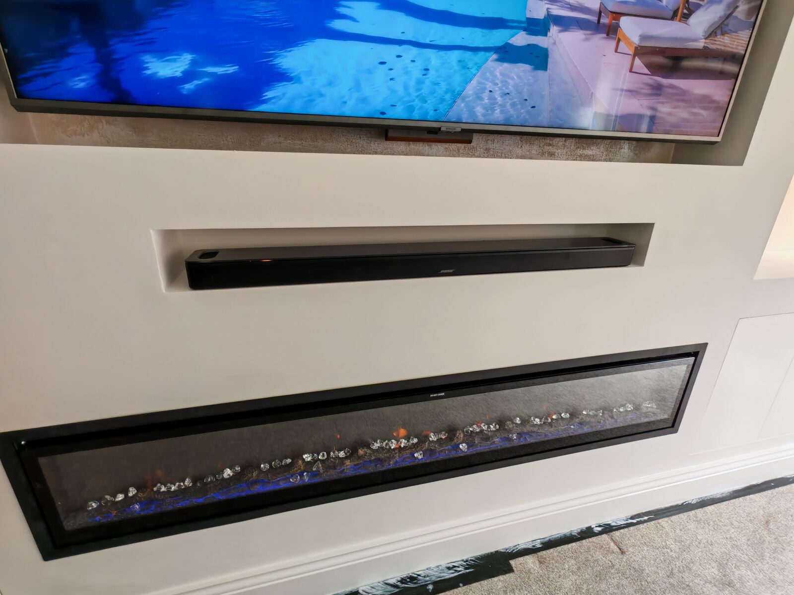 Media wall detail with soundbar recess and fireplace