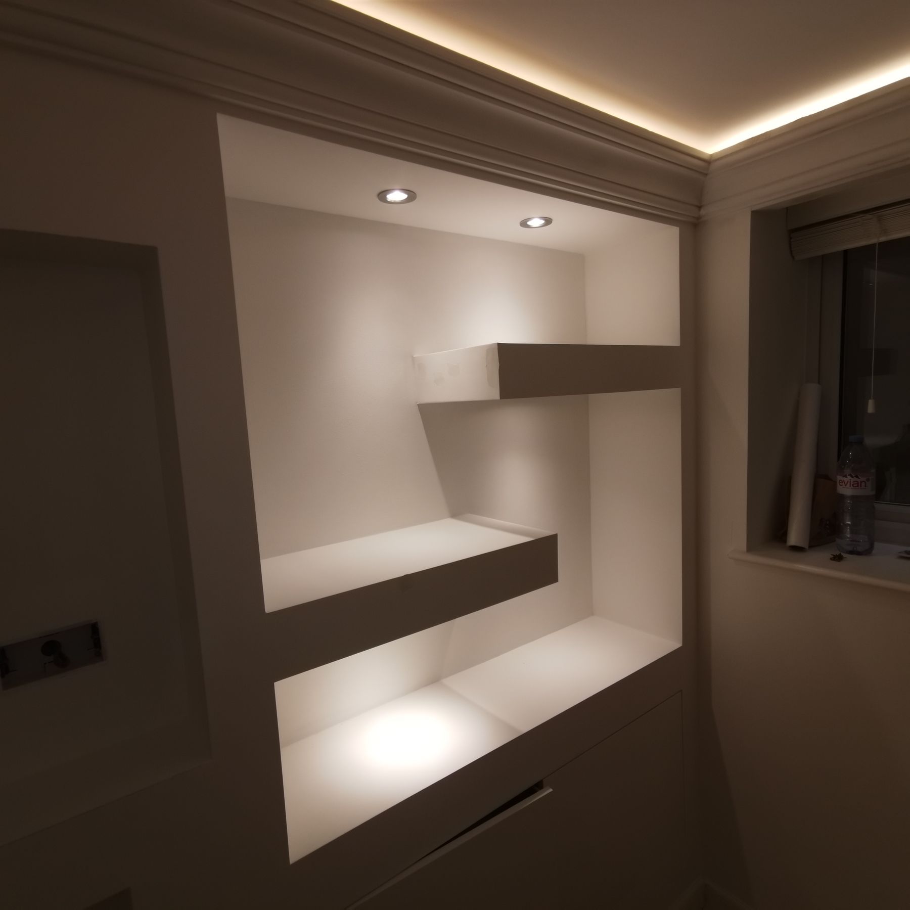 Close-up of an asymmetric backlit shelving detail, warm LED lighting
