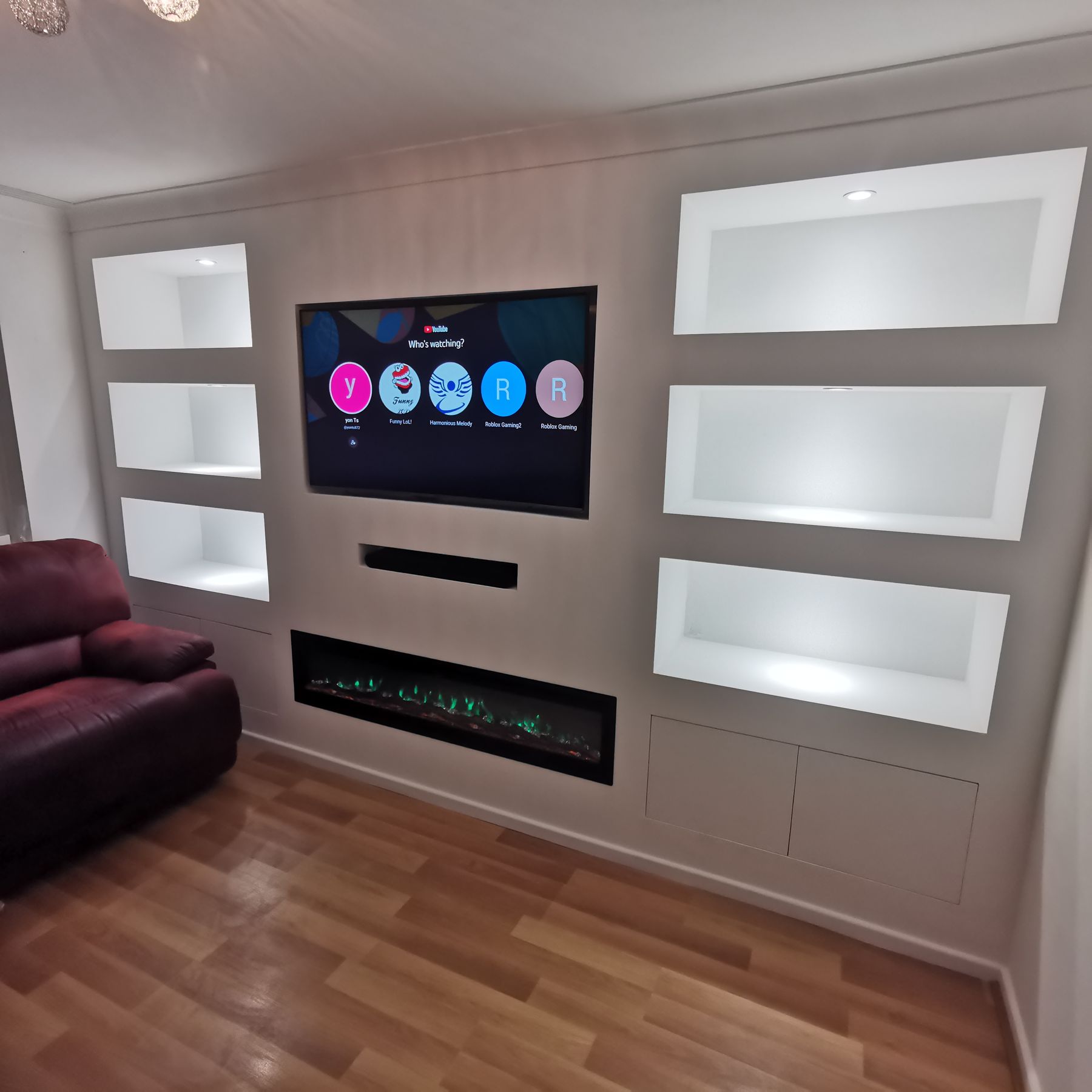 Finished gloss media wall with green flame-effect fire